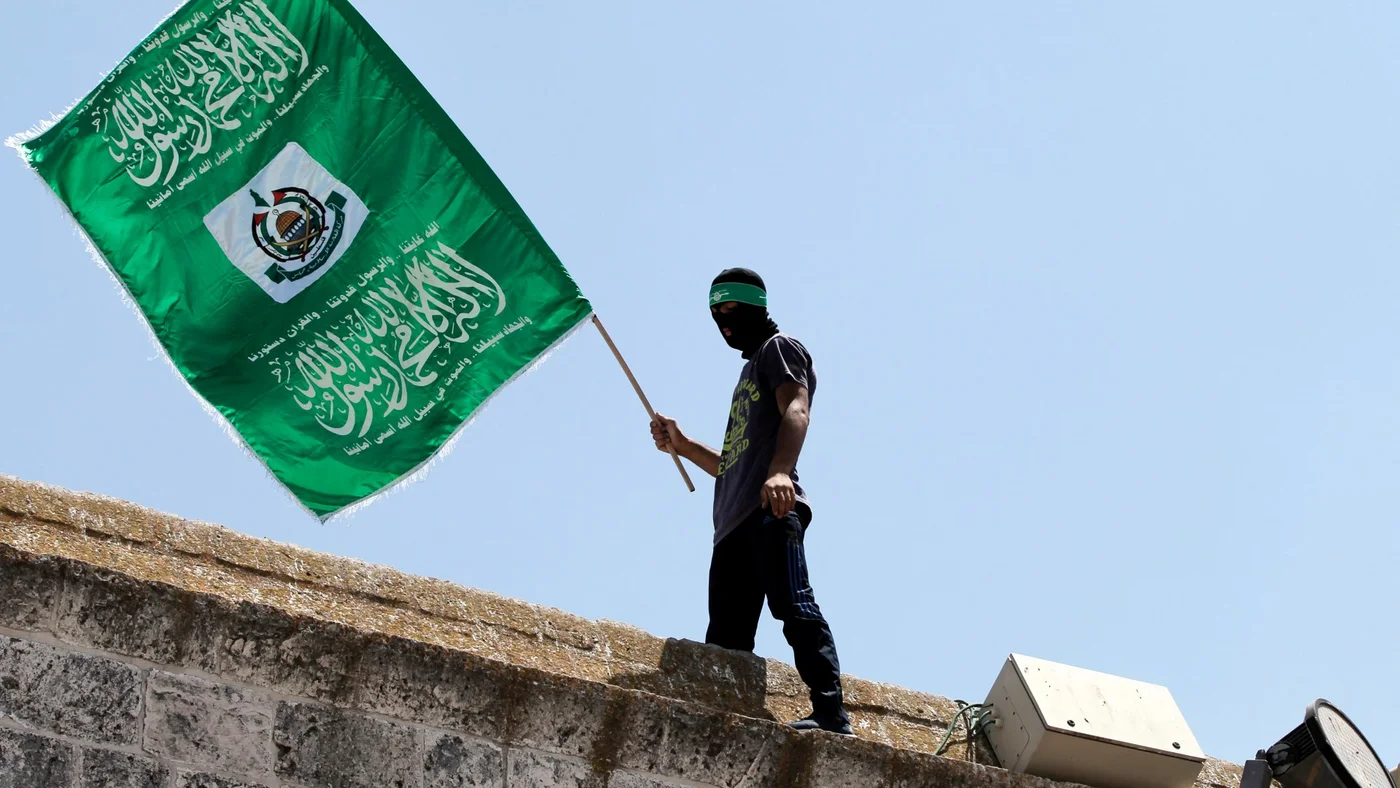palestinian-man-waves-hamas-flag-jerusalem-3-jul-2015-afp.jpg