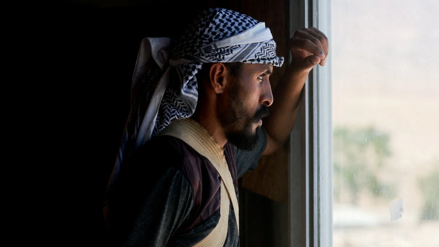 A Palestinian Bedouin stands inside his home as others flee, while settler violence surges, near Jericho in the Israeli-occupied West Bank, July 4, 2025.jpg