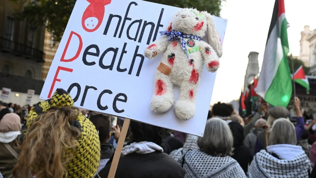A woman holds a placard reading “Infant Death Force” as demonstrators from the 22 gather in support for Palestinians in London on 11 October, 2025-reuters.jpg