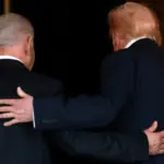 U.S. President Donald Trump and Israeli Prime Minister Benjamin Netanyahu embrace as they walk into Trump's Mar-a-Lago club in Palm Beach, Florida, U.S., December 29, 2025-reuters.jpg