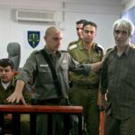 Ahmed Saadat (R), a Palestinian militant leader seized by Israel from a West Bank prison, is escorte..