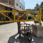 A-Palestinian-man-tries-to-pass-under-an-iron-gate-in-Hebron-as-Israel-tightens-the-movement-there-Photo-by-Sari-Jaradat-1791707979